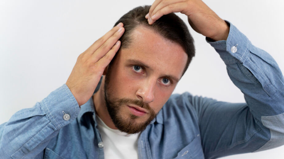 Adult male looking at his hairline